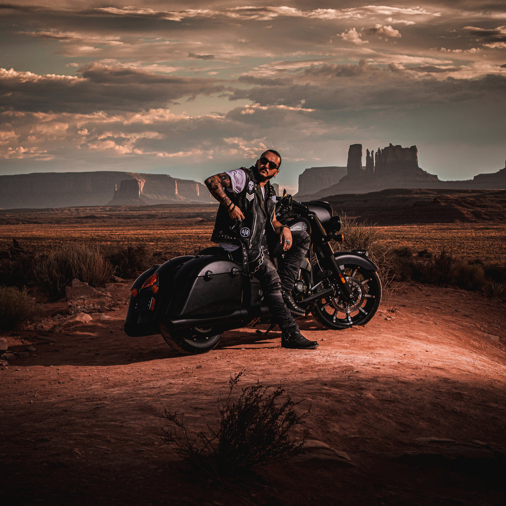 Singer Crucifix sitting on an Indian Motorcycle at Forrest Gump Point in Monument Valley Arizona. SaintCruce