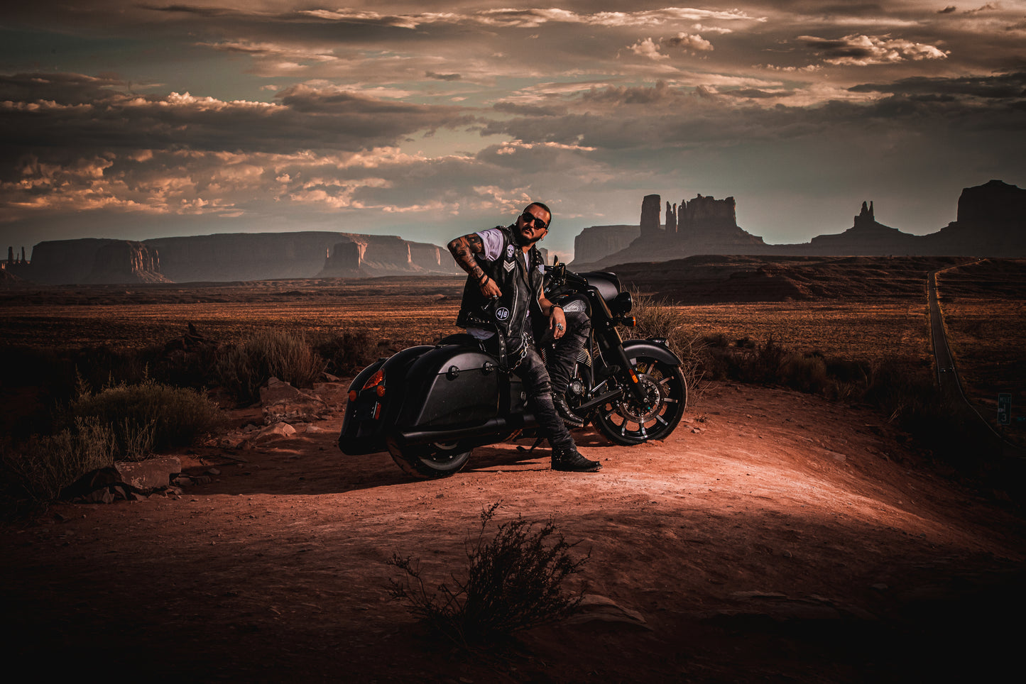 Singer Crucifix sitting on an Indian Motorcycle at Forrest Gump Point in Monument Valley Arizona. SaintCruce