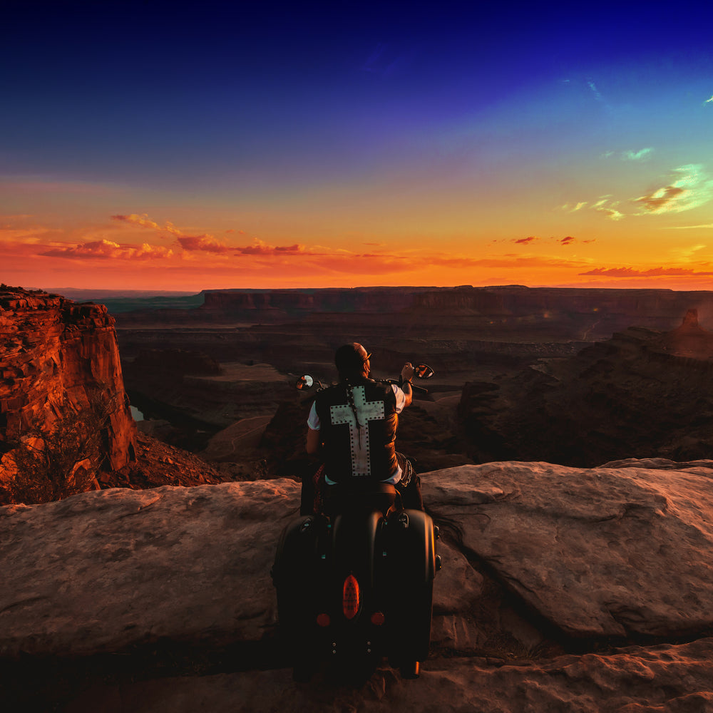 Singer Crucifix parks Indian Motorcycle on the edge of Dead Horse Point overlooking Horseshoe Bend in Moab Utah. SaintCruce