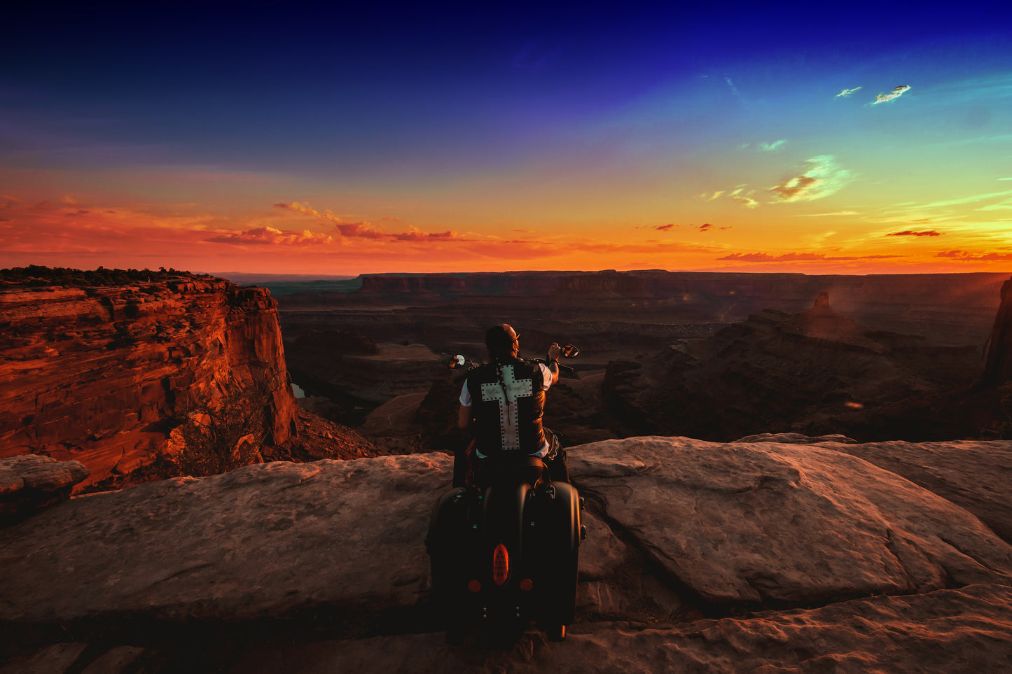 Singer Crucifix parks Indian Motorcycle on the edge of Dead Horse Point overlooking Horseshoe Bend in Moab Utah. SaintCruce