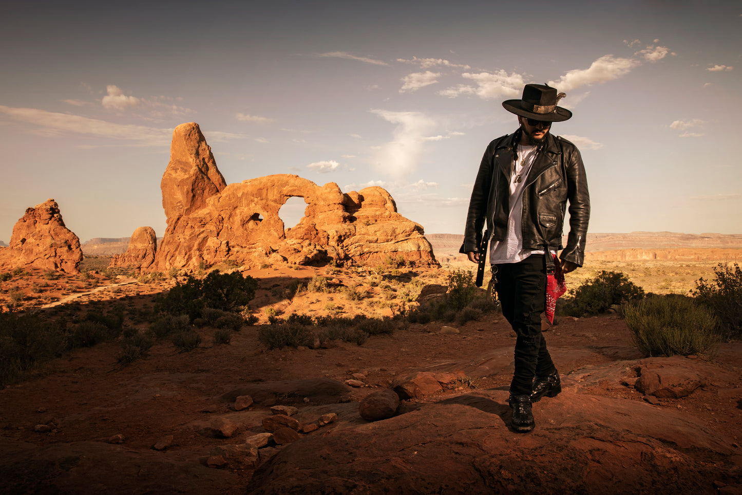 Singer Crucifix walking by the Turret Arch in Arches National Park Utah. SaintCruce