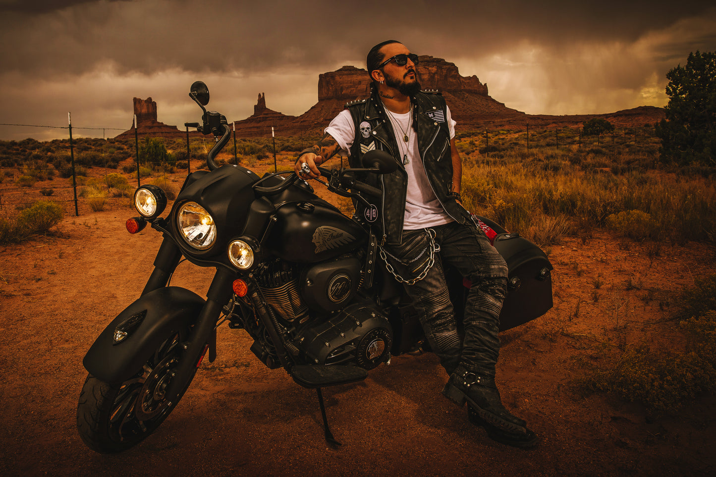 Singer Crucifix sits on an Indian Motorcycle between the Buttes of Monument Valley Utah. SaintCruce